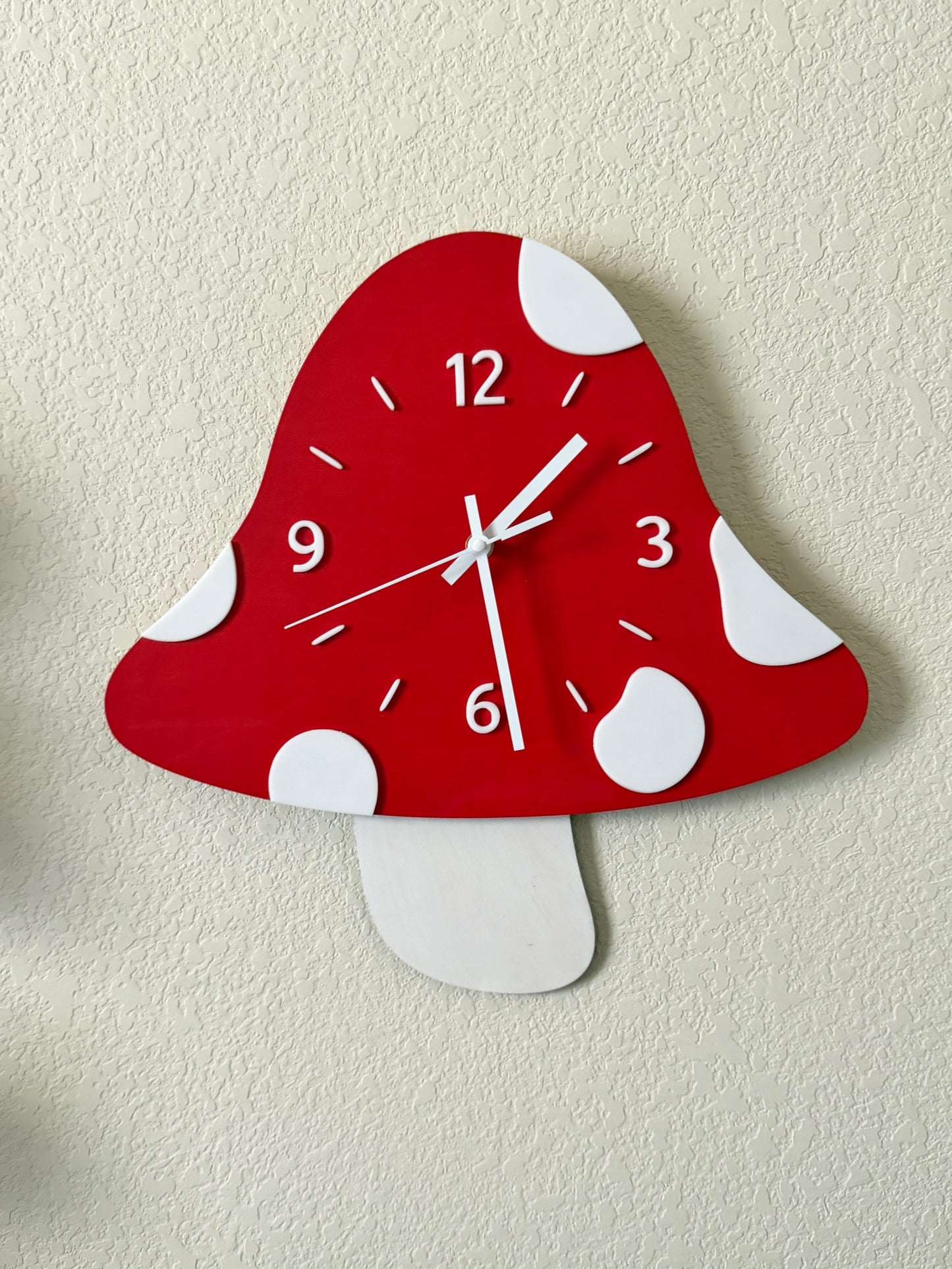 Red and white polka dot wall clock on a beige background