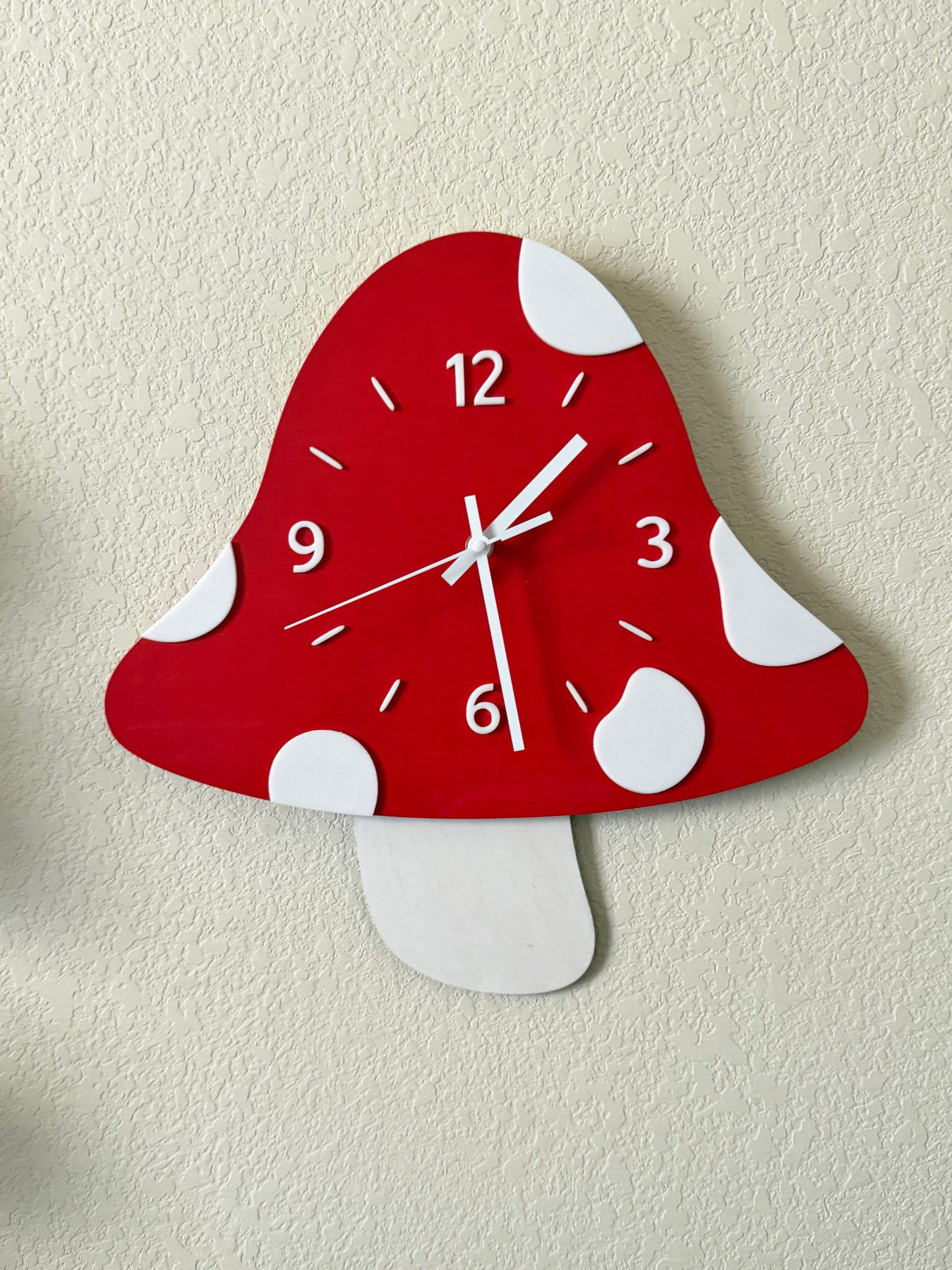Red and white polka dot wall clock on a beige background
