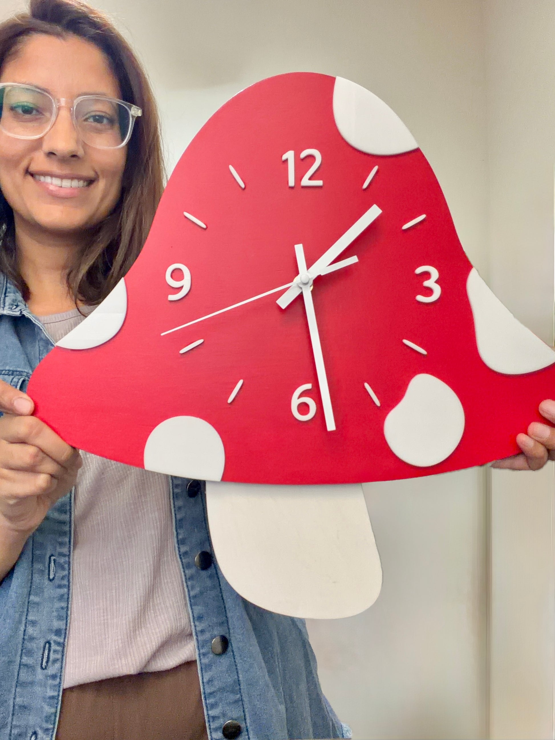 Person holding a red mushroom-shaped clock