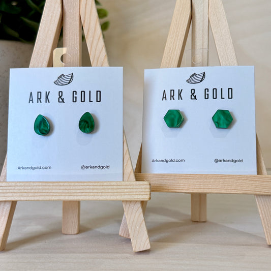 Green earrings on Ark & Gold branded cards with wooden stands.